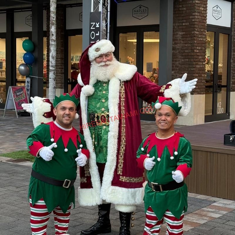 Hire Santa Miami Santa Claus and two elves greeting families at an outdoor shopping plaza